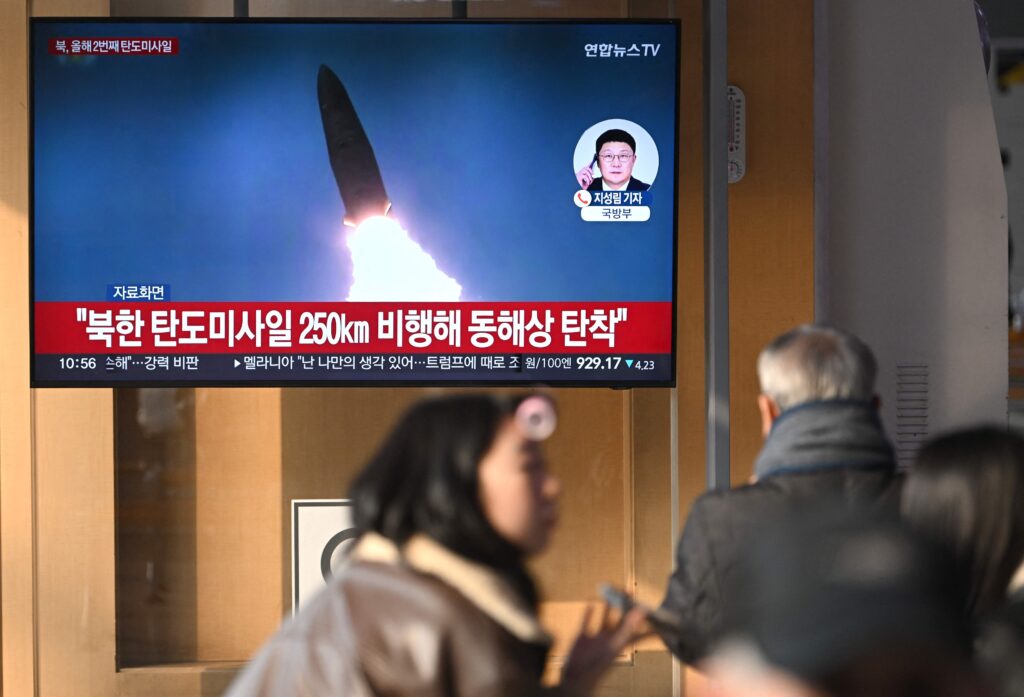 People watch a television screen showing a news broadcast with file footage of a North Korean missile test, at a train station in Seoul on January 14, 2025. North Korea launched several suspected short-range ballistic missiles on January 14, South Korea's military said, a week after Pyongyang reported firing a new hypersonic missile system. (AFP)