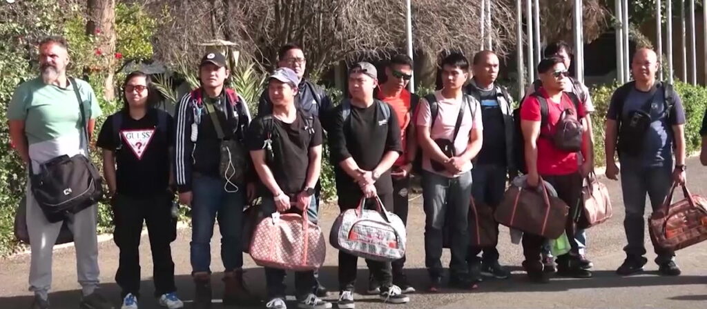 A handout screen grab taken from a video released by the Houthis media center shows crew members of the cargo vessel Galaxy Leader waiting to leave Sana'a airport after they were released by the Houthis, in Sana'a, Yemen, 22 January 2025. (EPA/Houthis Media Center)