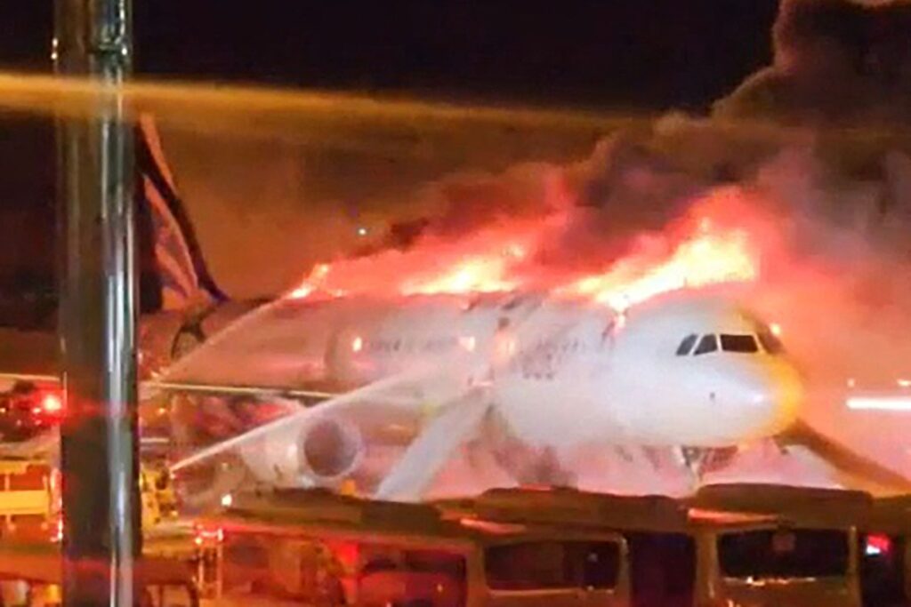 Fire authorities work to extinguish a fire that broke out on an Air Busan passenger plane at Gimhae International Airport in Busan on January 28, 2025. The tail of a passenger aircraft caught fire at an international airport in South Korea's second-largest city on January 28, forcing the evacuation of 176 people on board, Yonhap news agency reported. (AFP) 