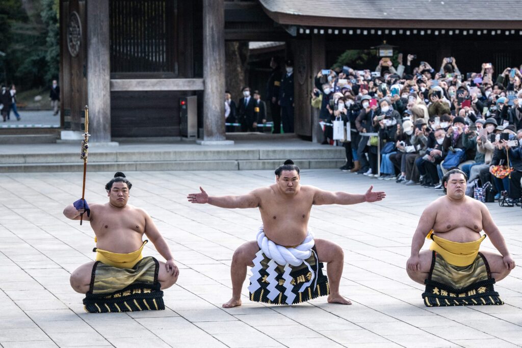 Mongolian born sumo wrestler and new yokozuna, or grand champion, Hoshoryu (C) performs the ring-entering ceremony at Meiji Shrine in Tokyo on January 31, 2025. (Photo by Philip FONG / AFP)