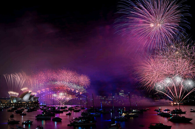 Fireworks explode over the Sydney Opera House and Harbour Bridge during New Year's celebrations. (Reuters)