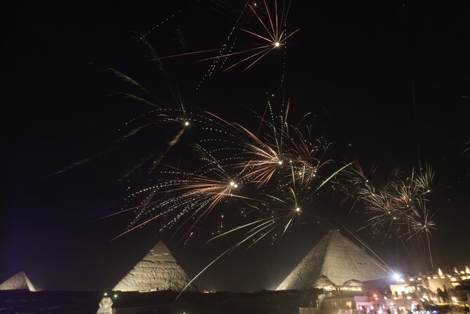 Fireworks spark over the historical site of Giza Pyramids, marking the new year, just outside Cairo, Egypt. (AP)