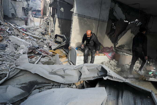 Palestinians inspect the site of an Israeli strike on a house in Gaza City, January 5, 2025. (Reuters)