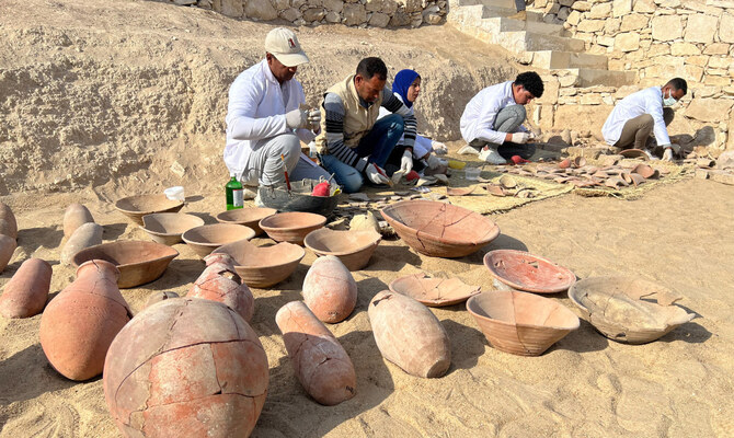 Archeologists carry out restoration work on the newly discovered artefacts, near the Queen Hatshepsut Valley Temple’s in Deir El-Bahari on the Nile’s west bank in Luxor on Wednesday. (Reuters)