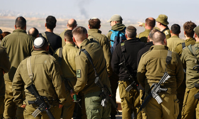 Israeli soldiers look towards Beit Hanoun, in the Gaza Strip, amid the ongoing conflict between Israel and Hamas, as seen from southern Israel, January 8, 2025. (Reuters)