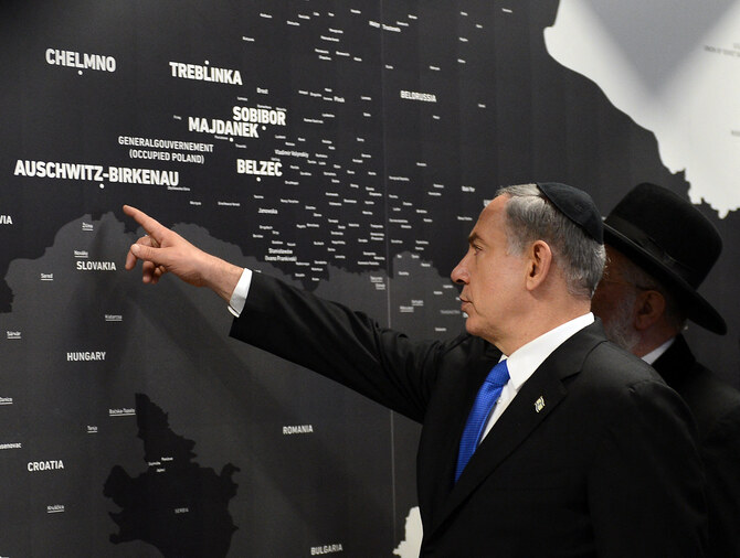 Israeli Prime Minister Benjamin Netanyahu attending an exhibition at the former Nazi death camp Auschwitz-Birkenau State Museum in Poland, June 2013 (File/AFP)