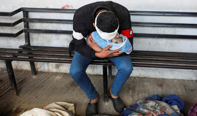 Belal Kullab holds his son, Adnan, who was killed in an Israeli strike. (Reuters)