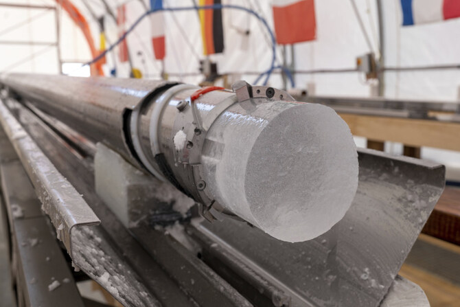An ice core drilled by a research team is displayed at Little Dome C field base in eastern Antarctica, during the cutting phase on Jan. 7, 2025. (PNRA/IPEV Beyond Epica via AP)