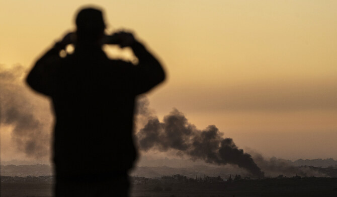 A man looks at smoke rising following an explosion inside the Gaza Strip, from an observation point in Sderot, southern Israel, on Jan. 13, 2025. (AP)