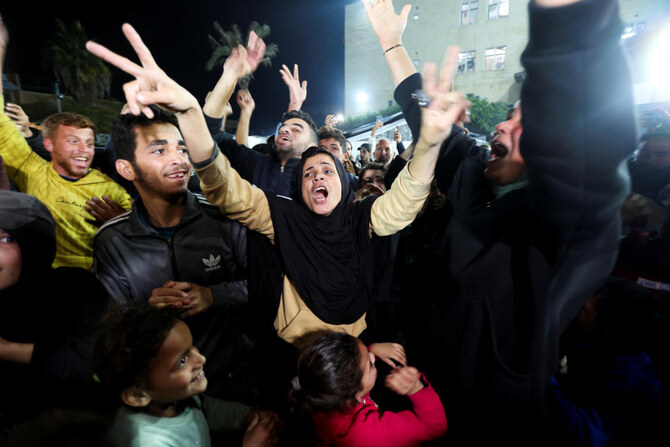 Palestinians react to news on a ceasefire deal with Israel, in Deir Al-Balah in the central Gaza Strip on Wednesday. (Reuters)