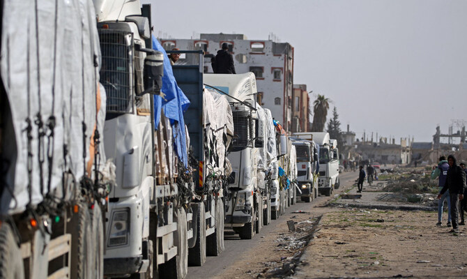 Trucks carrying humanitarian aid arrive in the Gaza Strip via the Kerem Shalom crossing, also known as Karem Abu Salem, on January 19, 2025. (AFP)