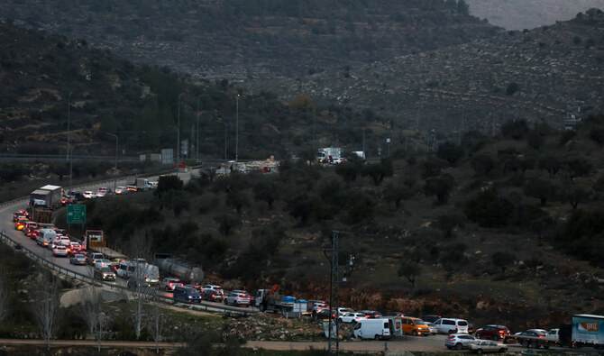 Commuters wait in their vehicles at the Israeli Atara checkpoint on route 465 near Ramallah in the occupied West Bank on January 22, 2025. (AFP)