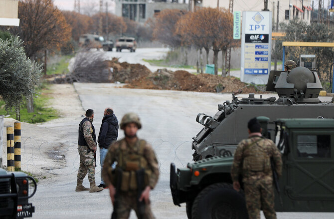 The ceasefire deal stipulated that Israeli forces should withdraw from south Lebanon within in a 60-day period, which ended on Sunday morning. Above, Lebanese army members secure the area as Israeli military vehicles are seen in the background in Burj Al-Muluk, near the southern Lebanese village of Kfar Kila. (Reuters)