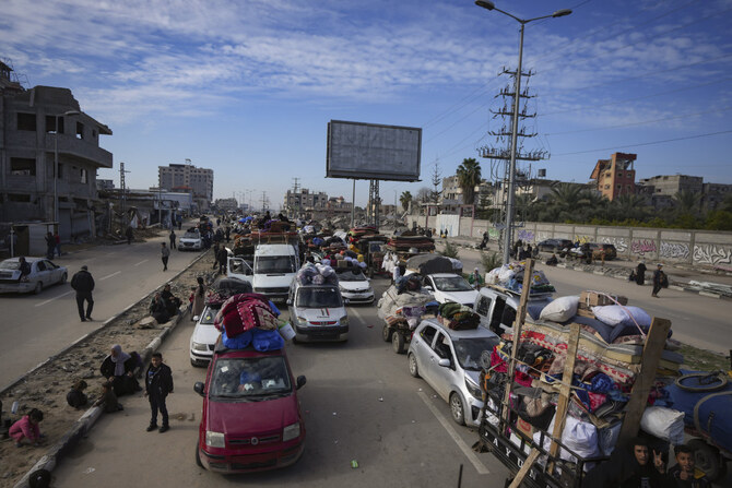 Displaced Palestinians with their belongings gather near a roadblock on Salah al-Din Street as they wait to return to their homes in the northern part of the Gaza Strip on Jan. 26, 2025, days after the ceasefire deal between Israel and Hamas came into effect. (AP)