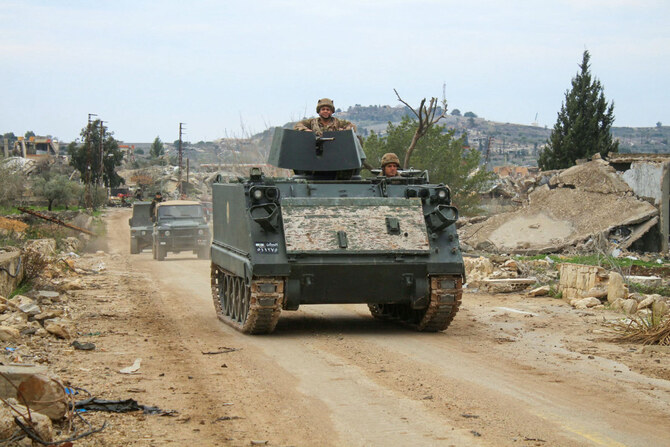 Lebanese army vehicles drive past destroyed buildings in the southern Lebanese village of Yarin on January 26, 2025.(AFP)