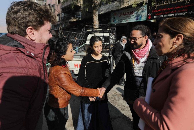 Syrian activist and former refugee Wafa Mustafa (C) talks to participants after a demonstration in Damascus on January 1, 2025. (AFP)