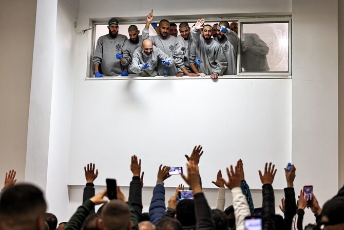 People cheer for Palestinian prisoners released by Israel upon their arrival at a sports centre building of the Ramallah municipality in the occupied West Bank, Jan. 25 (AFP)