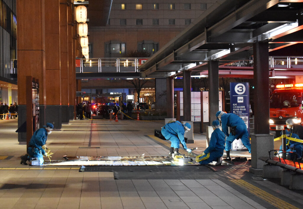 Investigators inspect the scene outside the JR Nagano train station after a man stabbed three people at a bus stop in the city of Nagano. (AFP)