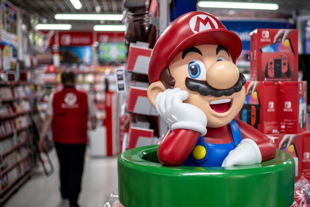 This file photo taken on January 16, 2025 shows Nintendo character Mario as an employee (L) walks past in the gaming section for Nintendo Switch products at a shop in Tokyo. Nintendo were expected to announce their third quarter results later on February 4, 2025. (AFP)