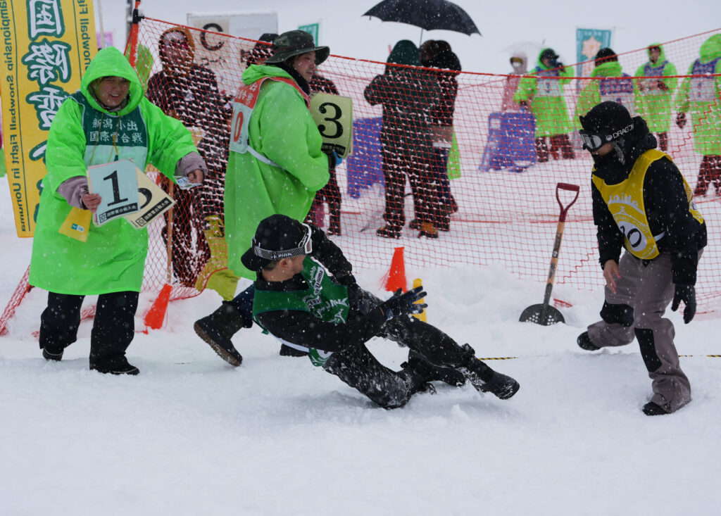 A man falls while throwing a snowball at the 35th Koide International Snowball Fight in Uonuma, Niigata Prefecture, Japan, February 9, 2025. (Reuters)