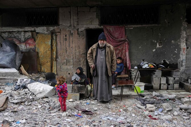 Talal Al-Assali, 64, poses in front of his destroyed home in Jabalia, northern Gaza Strip, on February 9, 2025. (AFP)