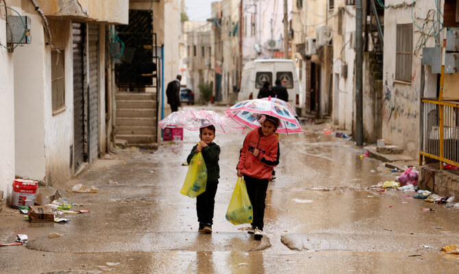 Palestinians children carry bottles of water amid disruption of water supply, in the aftermath of an Israeli raid, in Al-Faraa refugee camp near Tubas, in the Israeli-occupied West Bank, February 12, 2025. (Reuters)