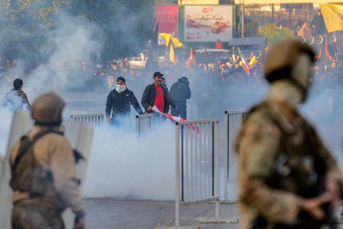 Teargas fumes erupt during clashes between supporters of the Lebanese Shiite Islamist movement Hezbollah and the Lebanese Army amidst a Hezbollah-organised rally to block the road to Beirut International Airport over a decision to bar two Iranian flights from landing there, in Beirut on February 15, 2025. (AFP)