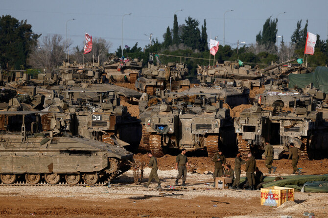 Israeli soldiers work by military vehicles near the border with Gaza on February 15, 2025, amid a ceasefire between Israel and Hamas. (Reuters)