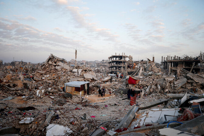 Palestinians gather among the rubble of buildings destroyed during the Israeli offensive, amid a ceasefire between Israel and Hamas, at Jabalia refugee camp, northern Gaza Strip, February 17, 2025. (REUTERS)
