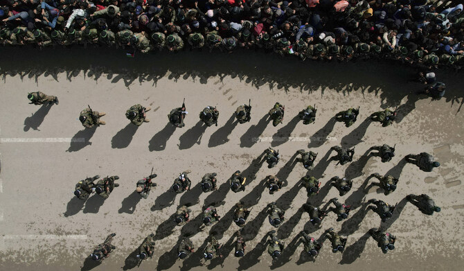 Palestinians gather as Hamas fighters deploy ahead of the planned release of Israeli hostages set to be handed over to the Red Cross in Nuseirat, Gaza Strip Saturday, Feb. 22, 2025. (AP)