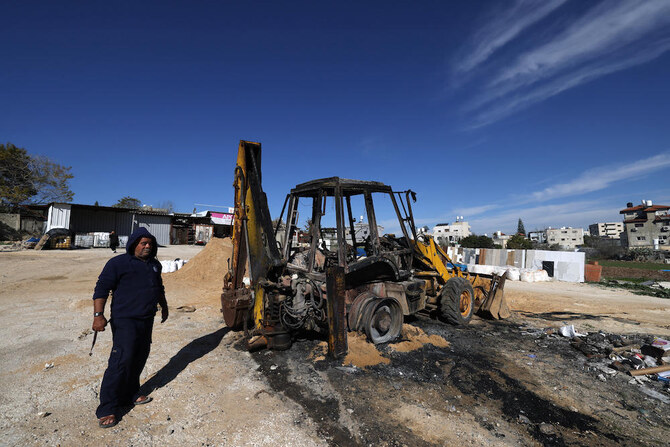 A man checks a burnt tractor following an attack by Israeli settlers in the Palestinian village of Jinsafut in the north of the occupied West Bank on Jan. 21, 2025. (AFP)