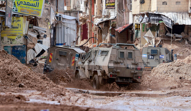 Israeli armoured vehicles drive through the the Jenin camp for Palestinian refugees in the occupied West Bank on February 24, 2025. (AFP)