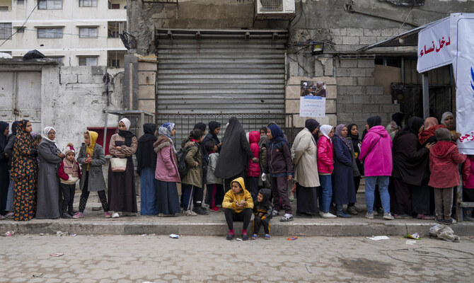 Palestinians queue to purchase bread outside a bakery in Gaza City, Monday, Feb. 24, 2025. (AP)
