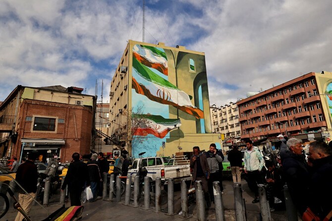 People walk in a commercial area in Tehran (AFP)