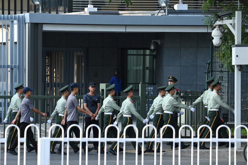 Chinese paramilitary police officers march past the entrance of the Japanese embassy in Beijing on September 19, 2024. (AFP)