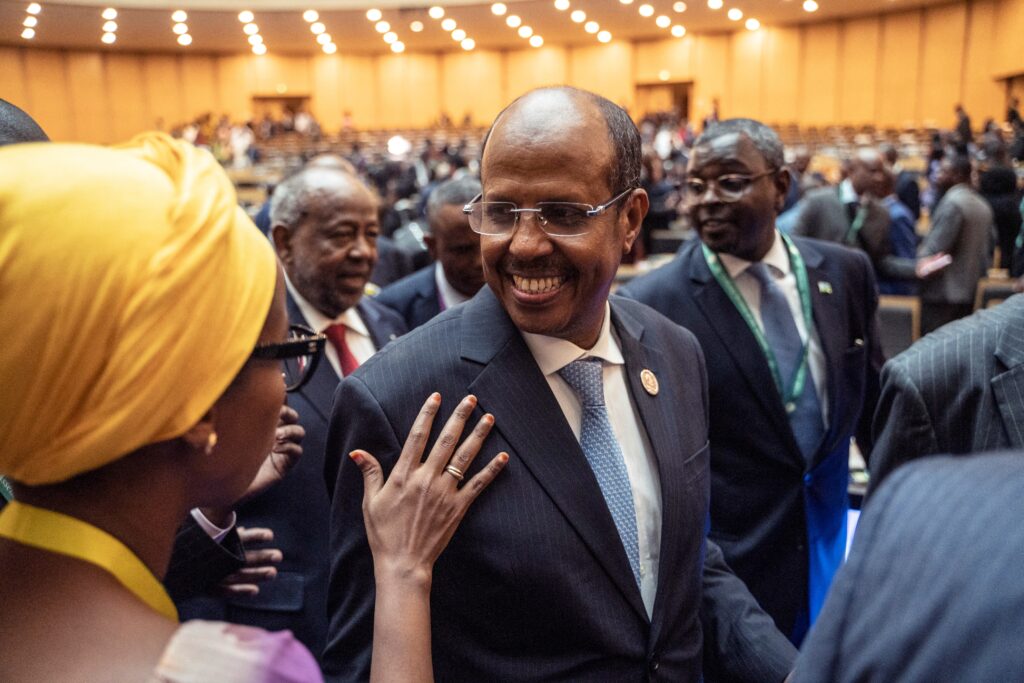 The newly elected chairperson for the Africa Union Commission Mahmoud Ali Youssouf (C) smiles after election results during the 38th African Union (AU) Summit, at the AU Headquarters in Addis Ababa on February 15, 2025. (AFP)