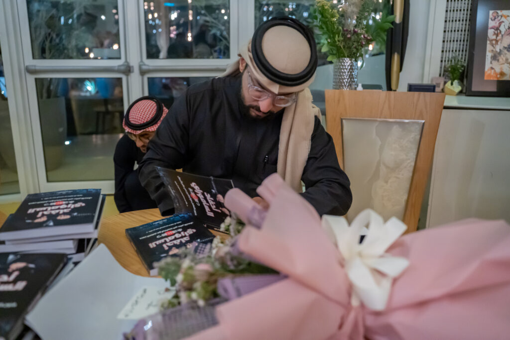Saudi writer Dr. Khalid Al-Rashoud signing his book “Descendants of the Samurai” for Arab News at releasing in Riyadh. (AN photo by Loai Elkelawy)