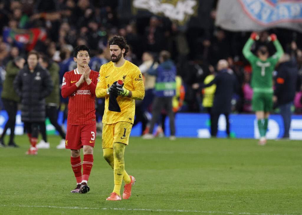 Liverpool's Wataru Endo and Alisson Becker look dejected after match. (via Reuters)