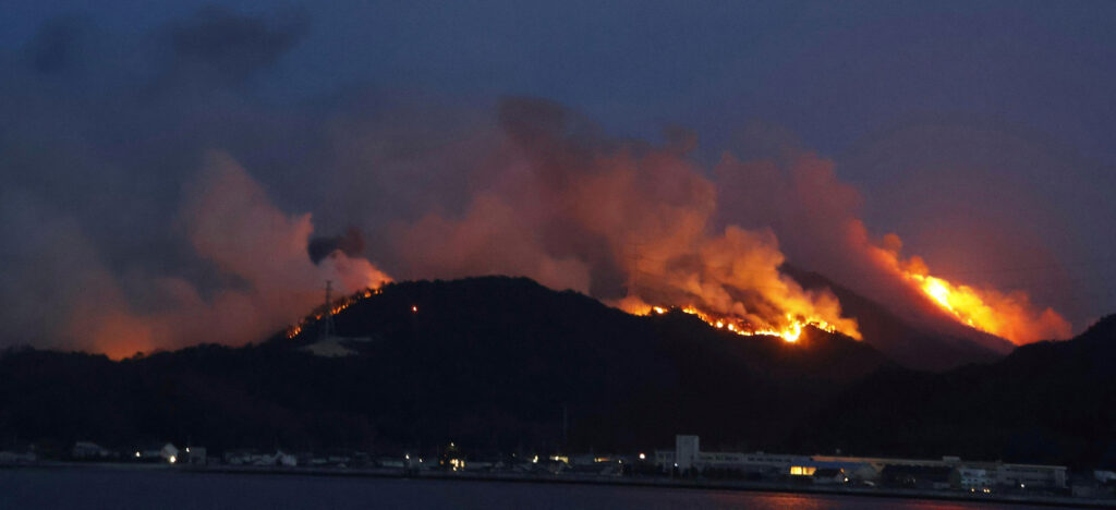 A forest fire burns in Okayama, western Japan Sunday, March 23, 2025. (Kyodo News via AP)