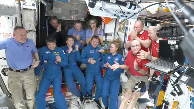 This image made from video by NASA shows astronauts greeting each other after the SpaceX capsule docked with the International Space Station, Sunday, March 16, 2025. (AP)