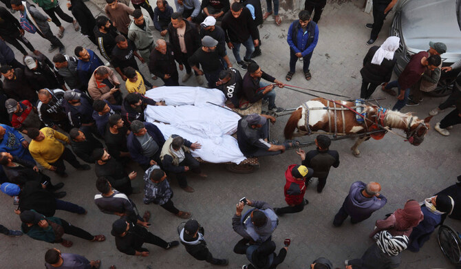 The bodies of victims killed in overnight Israeli airstrikes on the Gaza Strip are carried on a horse cart outside Al-Ahli Arab hospital, also known as the Baptist hospital, in Gaza City ahead of their burial on March 18, 2025. (AFP)