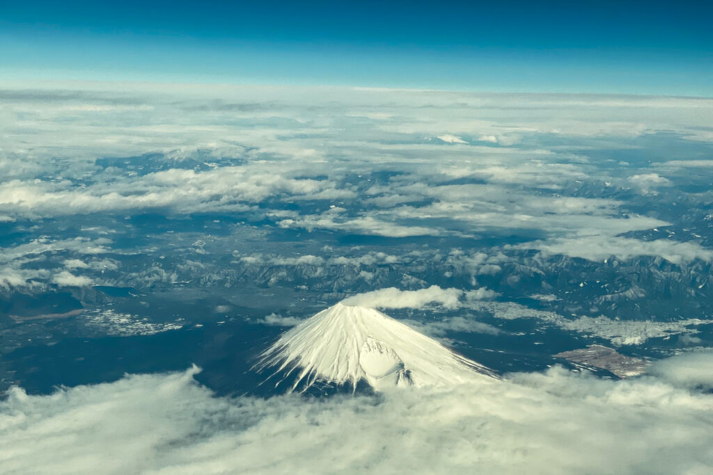 This aerial view of Mount Fuji, Japan's highest peak at 3,776 meters (12,388 feet), is seen from the window of a flight from Tokyo to Hong Kong, above Shizuoka Prefecture on March 1, 2024. (AFP)