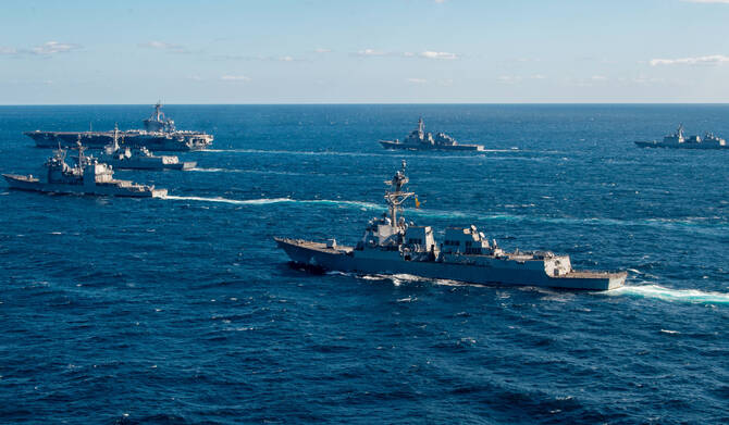 The US Navy USS Kidd (front R) following the US Navy aircraft carrier USS Carl Vinson (back L) as they take part in three-day trilateral military maritime exercises with the navies of Japan and South Korea, at an undisclosed location in the Pacific Ocean. (AFP)