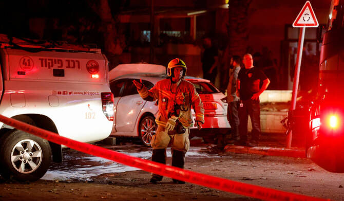 A firefighter stands at an impact scene following a hit by a rocket fired from the Gaza strip towards Israel, in Ashkelon, Israel April 6, 2025. (REUTERS)