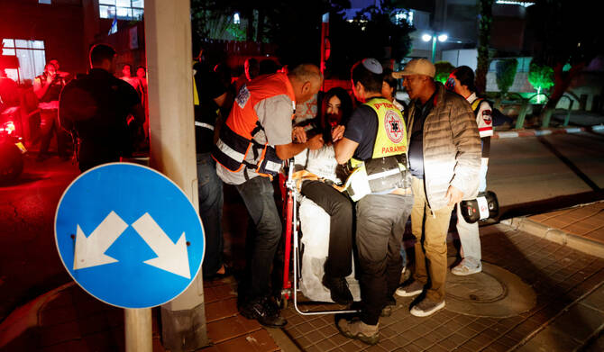 A woman receives assistance at an impact scene, following a hit by a rocket fired from the Gaza strip towards Israel, in Ashkelon, Israel April 6, 2025. (REUTERS)