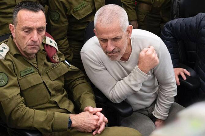 This handout picture released by the Israeli army shows (L to R) Israeli army Chief of the General Staff Lieutenant-General Herzi Halevi and Israel Security Agency (ISA, also known as Shin Bet) director Ronen Bar at the Hostages and Missing Persons situation room during the return of the four hostages from Gaza on January 25, 2025. (AFP)