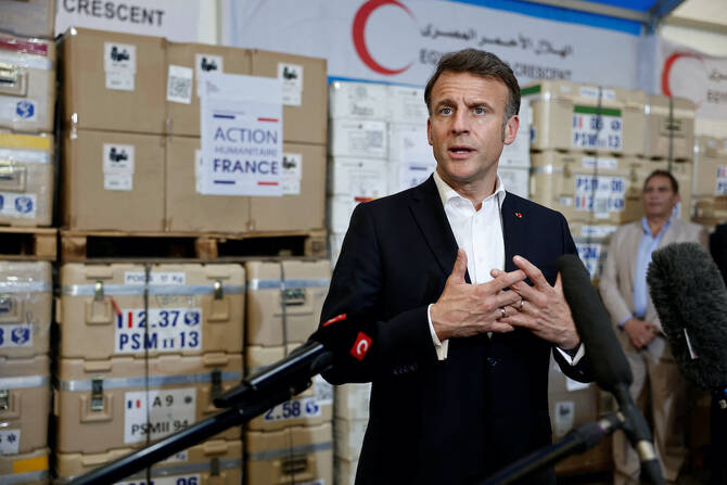 French President Emmanuel Macron (C), Egyptian President Abdel Fattah al-Sisi (3rd R) and Dr Amal Emam, CEO of the Egyptian Red Crescent (2nd L), visit Egyptian Red Crescent warehouses storing aid for Gaza, in the Egyptian border town of El-Arish. (AFP)