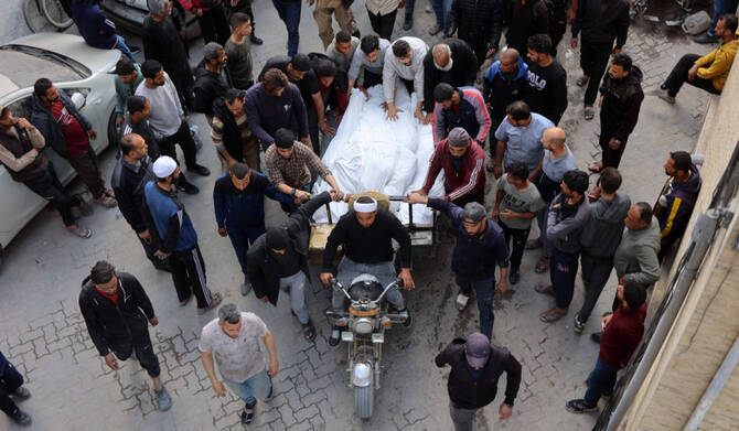 Palestinians transport the bodies people killed when an Israeli strike hit a building in Gaza City's eastern neighbourhood of Shujaiya, in the yard of the Al-Ahli Arab hospital in the northern Gaza Strip on April 10, 2025. (AFP)