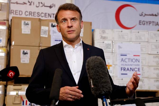 France’s President Emmanuel Macron delivers a speech in front of humanitarian aid destined to Gaza, at the Egyptian Red Crescent warehouse in Egypt. (File/AFP)