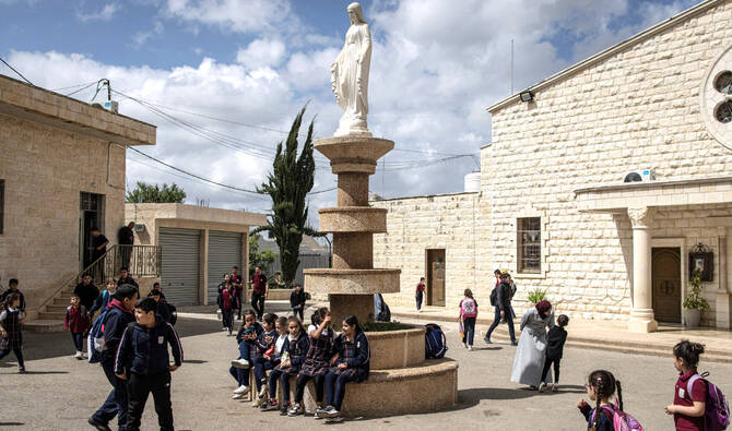 Students walk through a Christian school in the Palestinian town of Zababdeh, Israeli-occupied West Bank. (AFP)